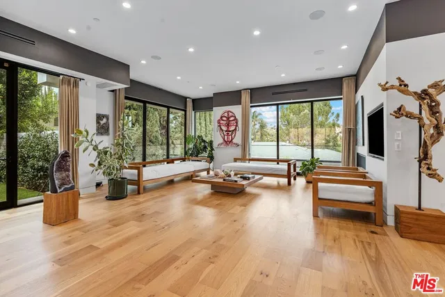 a view of a gym with large windows and wooden floor