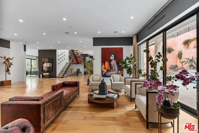 a living room with furniture and floor to ceiling window