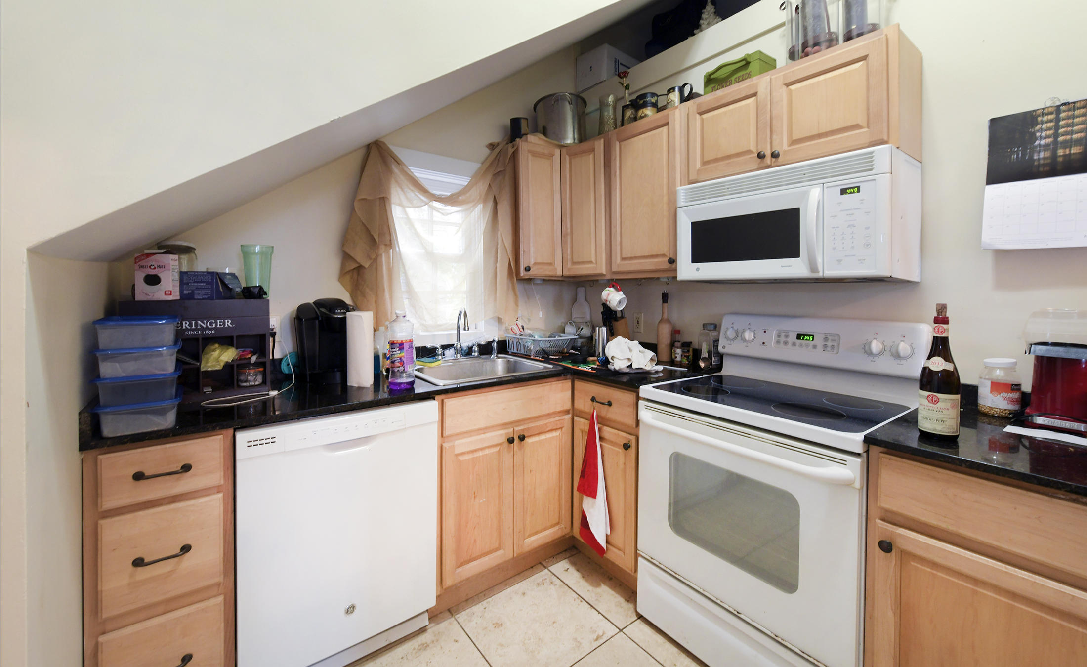 419 William Street, Unit 3 Key West, FL 33040 - Photo 6 of 12 a kitchen with cabinets appliances a sink and a counter top space