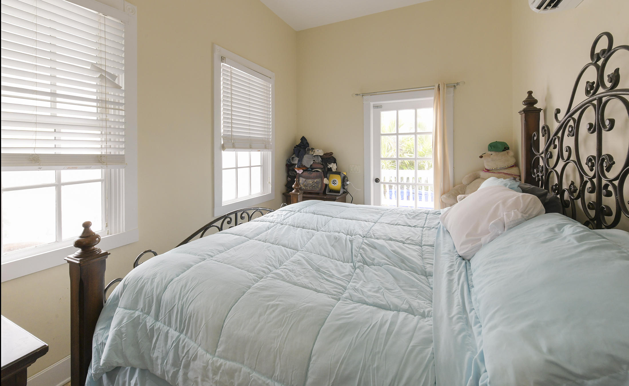 419 William Street, Unit 3 Key West, FL 33040 - Photo 7 of 12 a large bed sitting in a bedroom next to a window