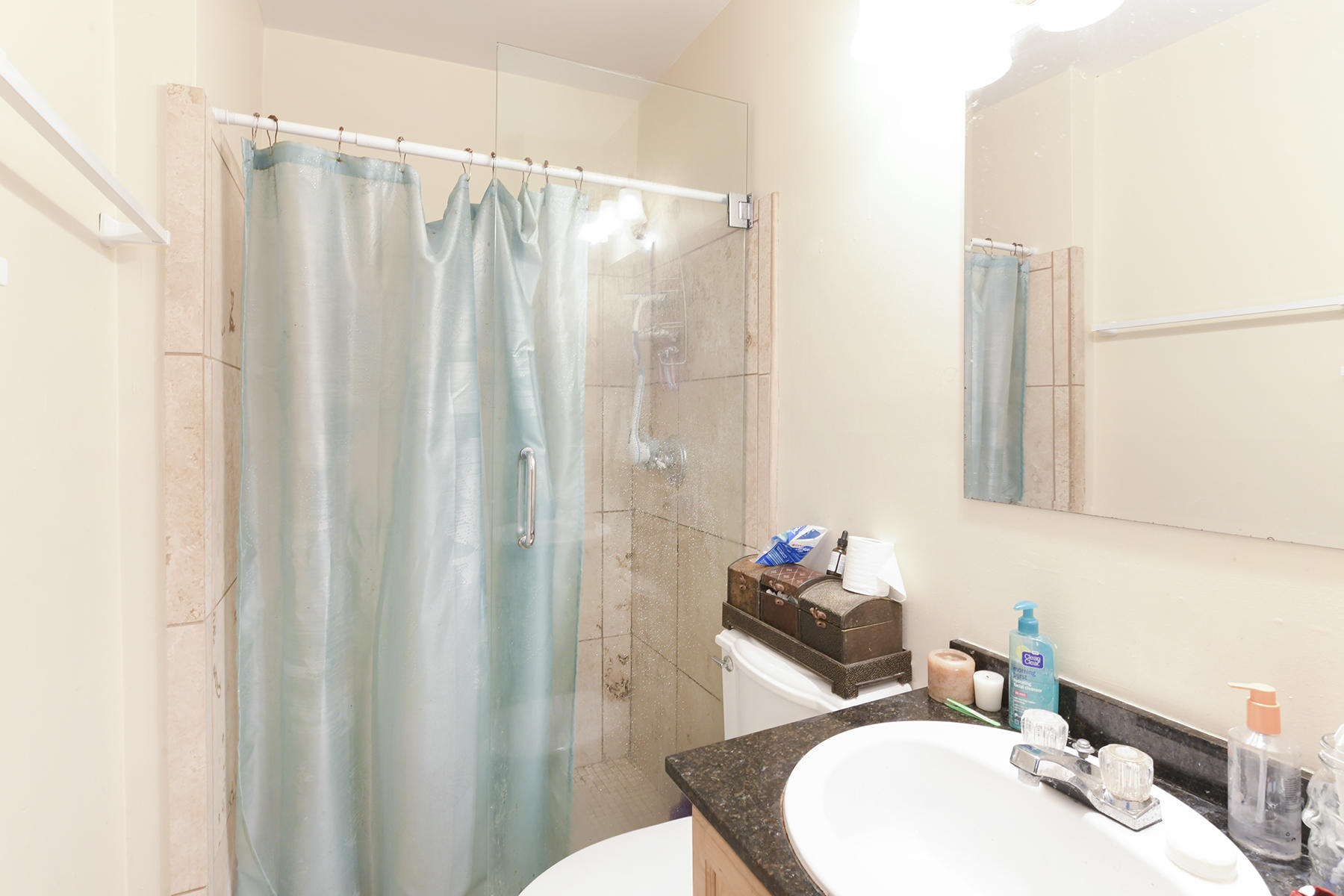 419 William Street, Unit 3 Key West, FL 33040 - Photo 8 of 12 a bathroom with a sink mirror and a shower curtain