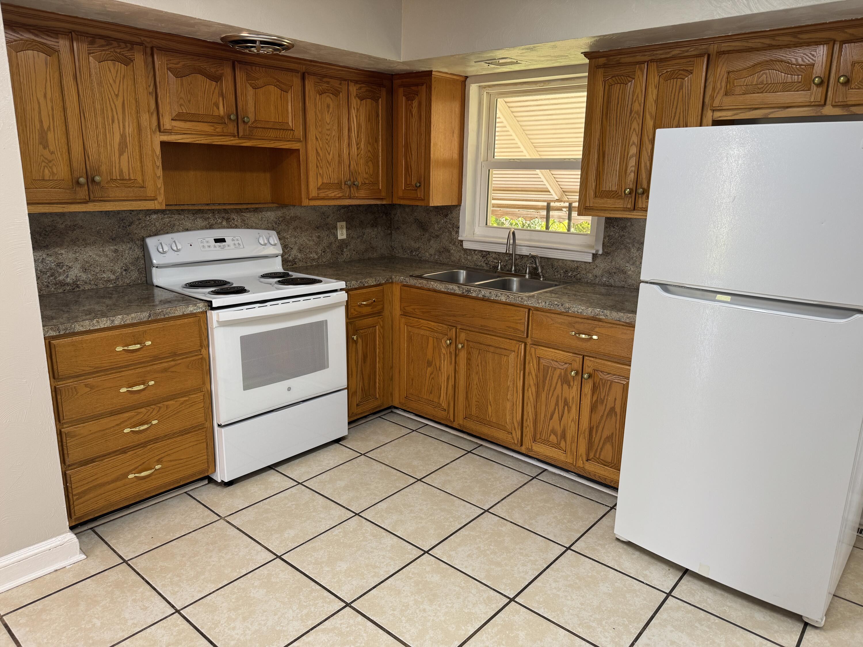 357 Terry Avenue Danville, VA 24540 - Photo 3 of 8 a kitchen with a refrigerator sink and cabinets