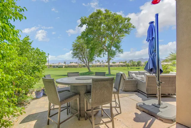 a dining area with furniture and garden view