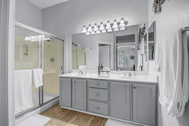 a bathroom with a sink a toilet and shower