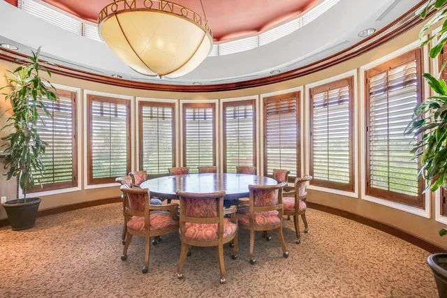 a view of a livingroom with furniture and floor to ceiling window
