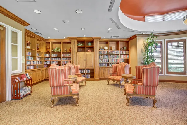 a room with furniture pool table and windows