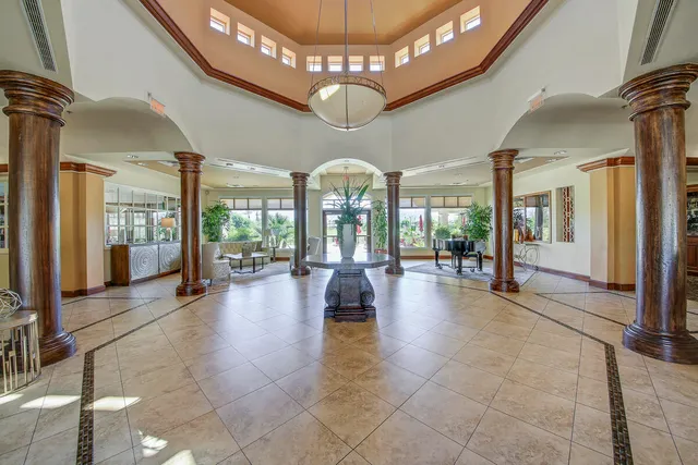 a very nice looking living room with a large window and kitchen view