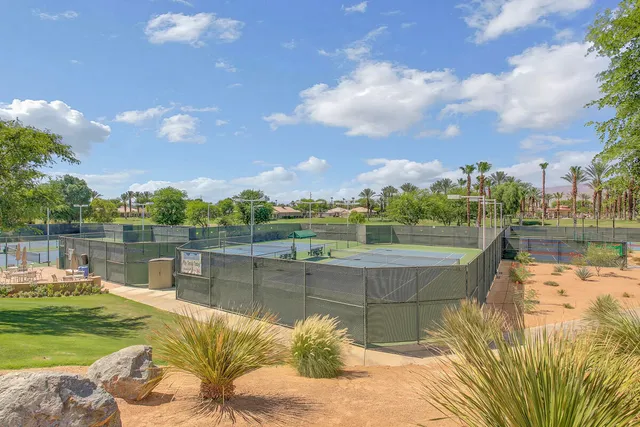 a view of a house with palm trees
