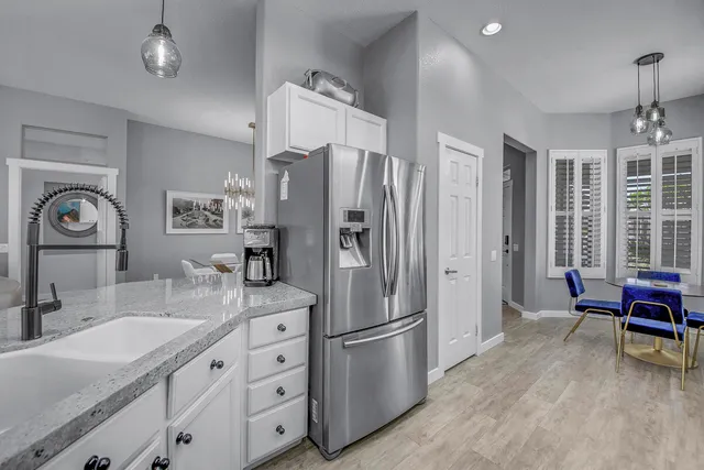 a kitchen with stainless steel appliances granite countertop a sink and a stove