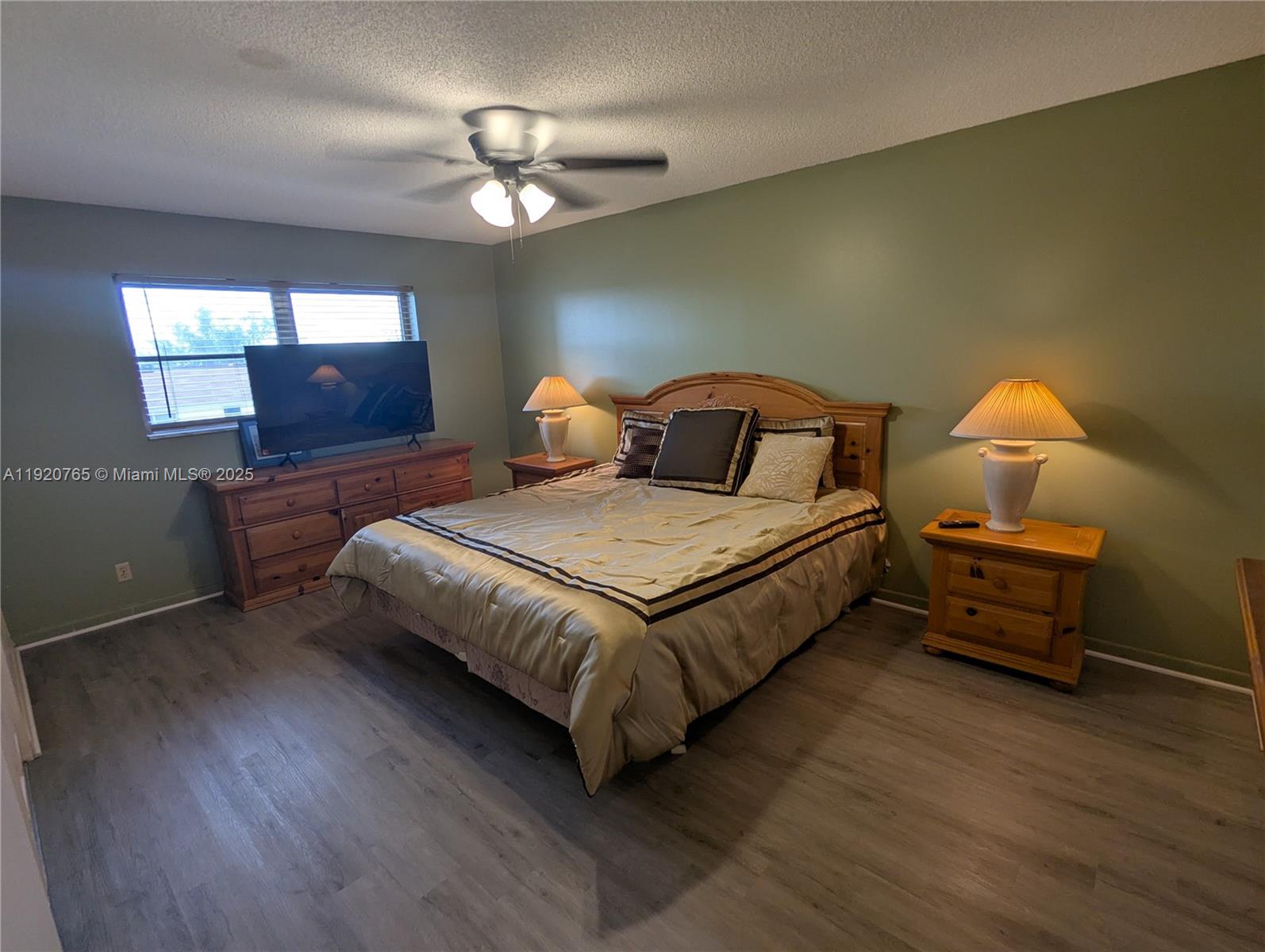 4047 Northwest 16th Street, Unit 403 Lauderhill, FL 33313 - Photo 25 of 30 a bedroom with a bed and a chandelier