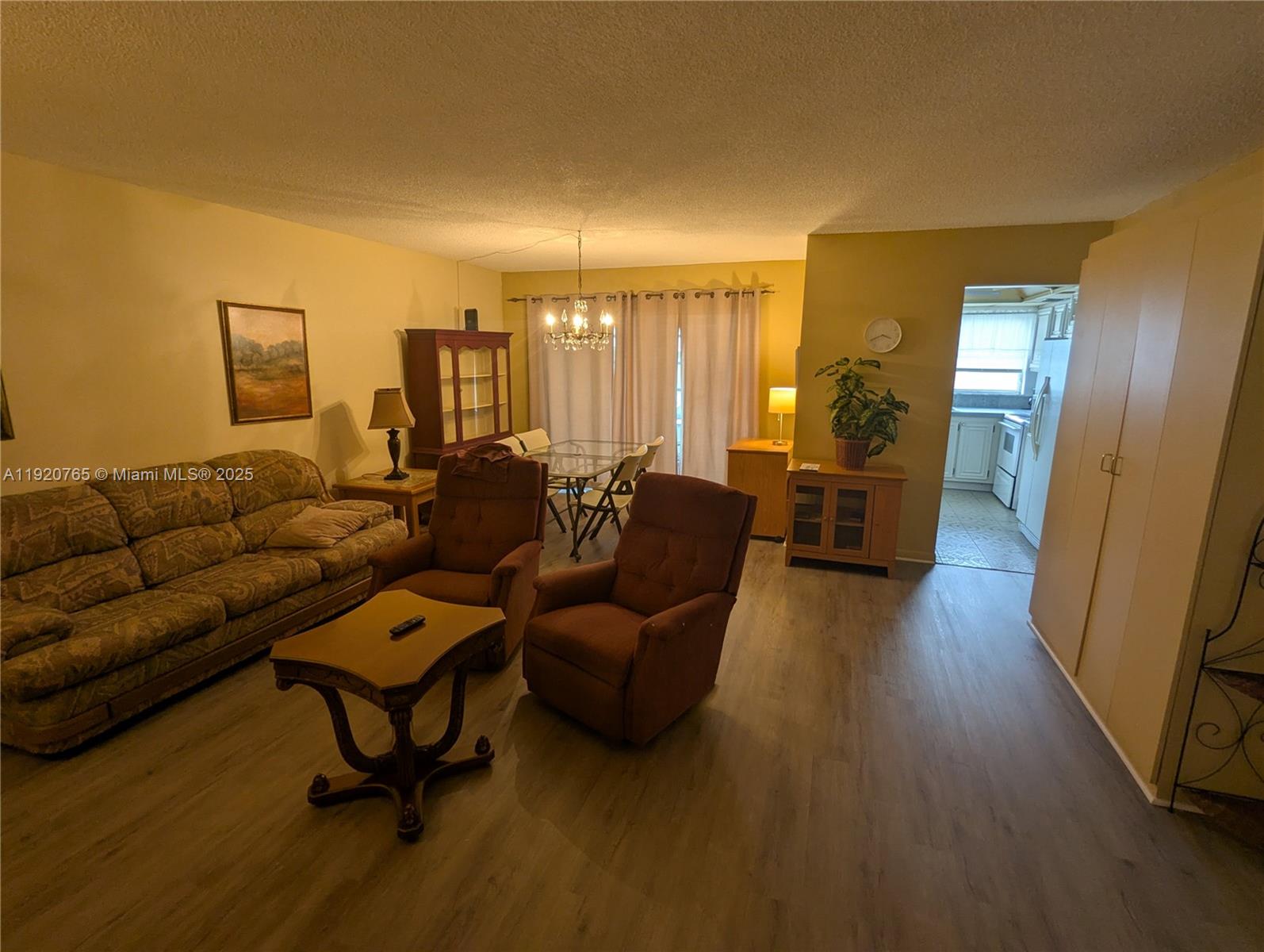 4047 Northwest 16th Street, Unit 403 Lauderhill, FL 33313 - Photo 29 of 30 a living room with furniture and a wooden floor