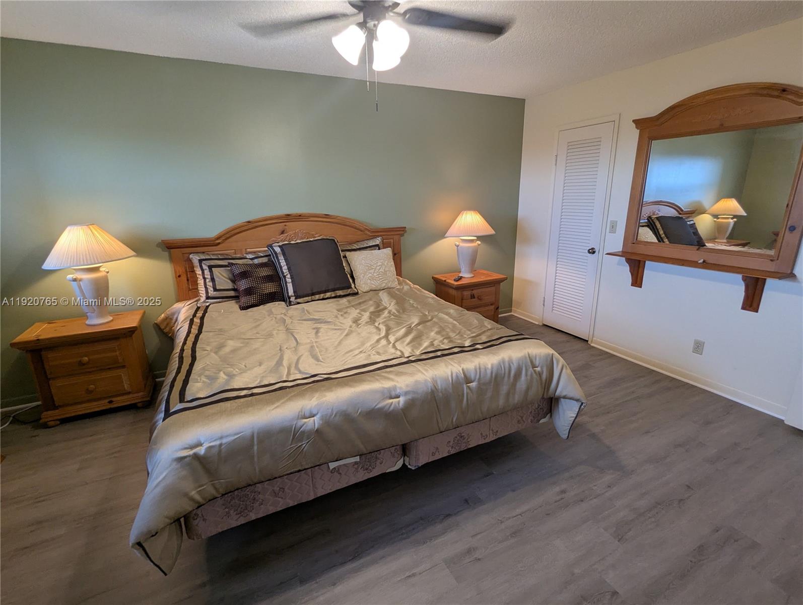 4047 Northwest 16th Street, Unit 403 Lauderhill, FL 33313 - Photo 3 of 30 a bedroom with a bed and a chandelier