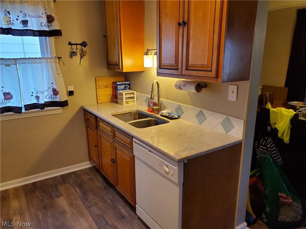 5615 Ridgewood Avenue Parma, OH 44129 - Photo 3 of 19 Cherry cabinets with granite countertops, vinyl plank floors and and stove ,refrigerater, dishwasher and microwave stay