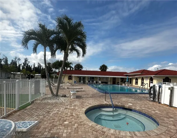 a view of a house with swimming pool and porch with furniture