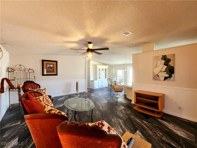 a living room with furniture a rug and a chandelier