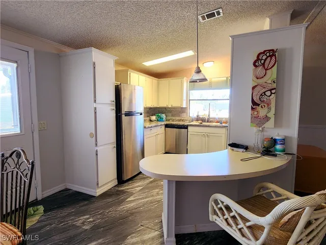 a kitchen with a table and chairs