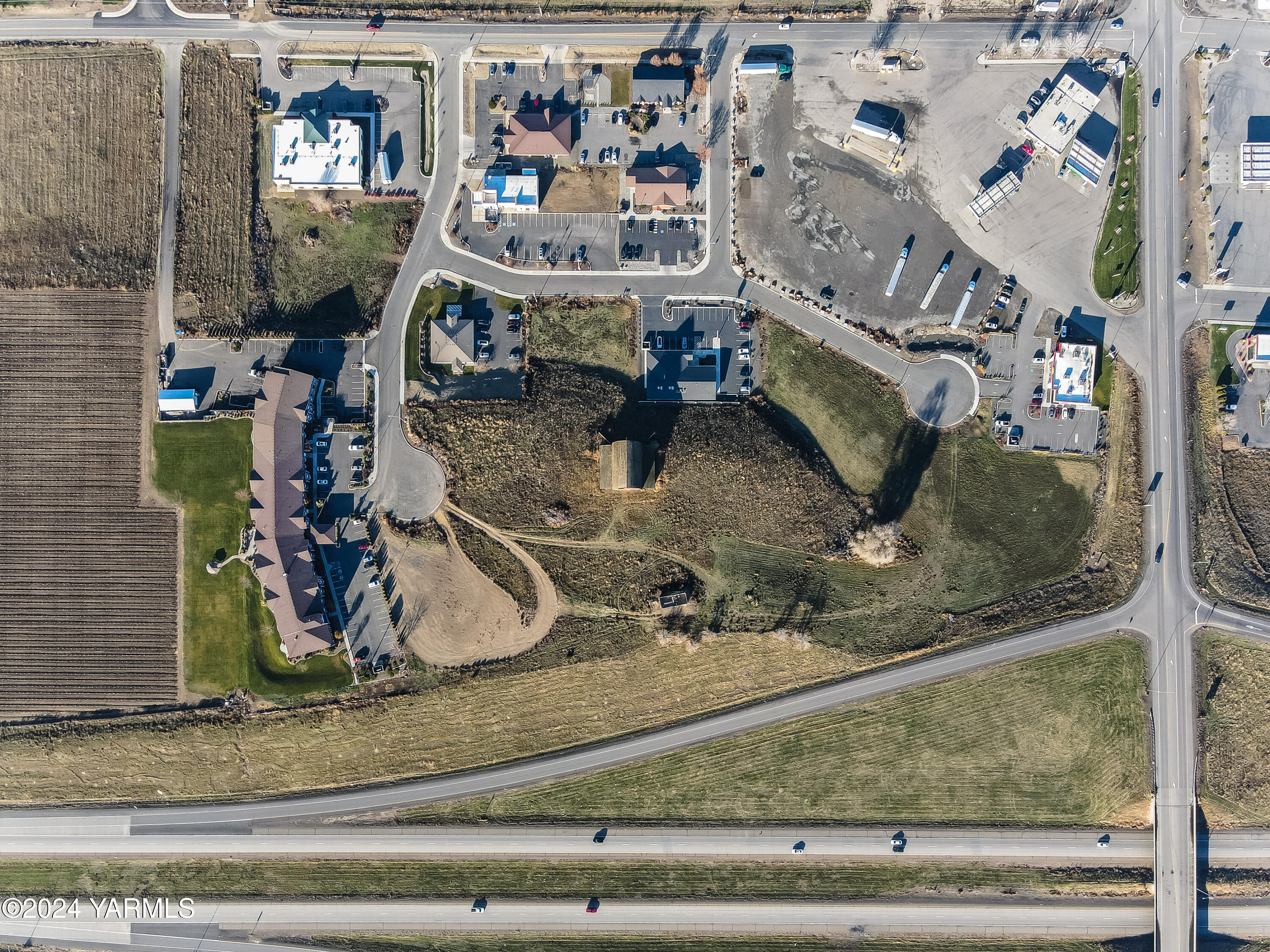 2675 Allen Road Sunnyside, WA 98944 - Photo 2 of 4 a room with lots of frames on wall and a potted plant