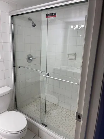 a bathroom with a shower and a toilet