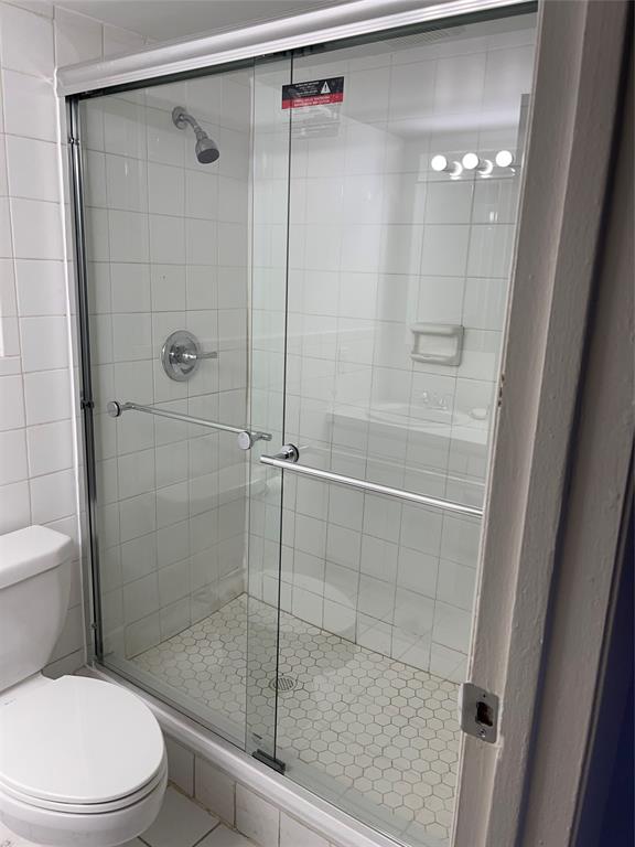 8405 Northwest 61st Street, Unit D109 Tamarac, FL 33321 - Photo 11 of 25 a bathroom with a shower and a toilet