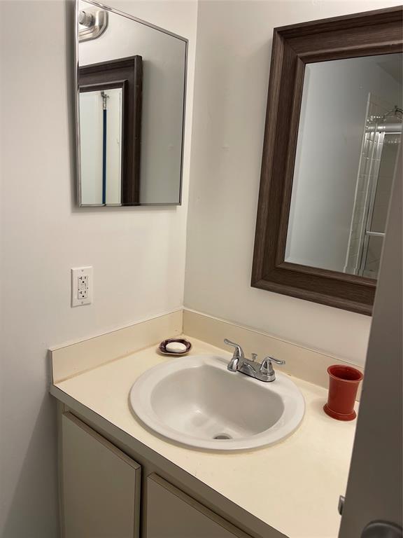 8405 Northwest 61st Street, Unit D109 Tamarac, FL 33321 - Photo 12 of 25 a bathroom with a sink and a mirror