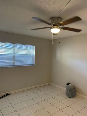 a close view of a refrigerator in kitchen and wooden floor