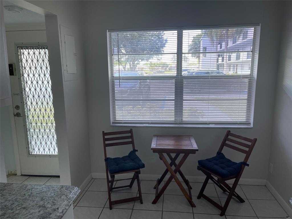 8405 Northwest 61st Street, Unit D109 Tamarac, FL 33321 - Photo 16 of 25 a view of a dining room with furniture and window