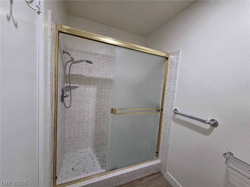 3317 Racquet Street Las Vegas, NV 89121 - Photo 8 of 23 This bathroom features a shower with tiled walls and a glass enclosure.