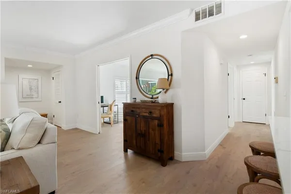 a view of a livingroom with furniture and a entryway