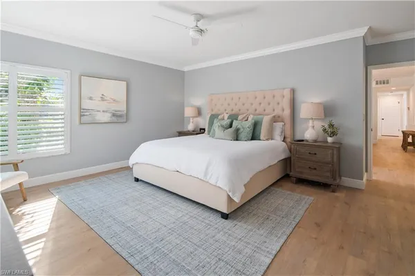 a bedroom with a bed a couch and a window