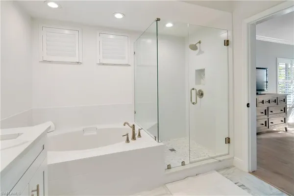 a bathroom with a bathtub shower and toilet