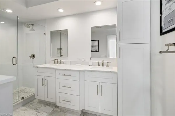 a bathroom with a double vanity sink mirror and double