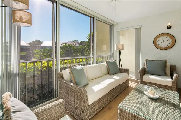 a living room with furniture and a floor to ceiling window