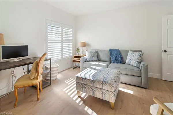 a spacious bedroom with a bed and a couch