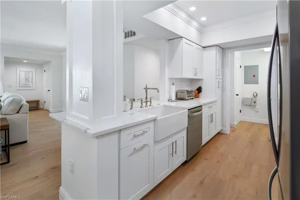 a kitchen with sink a refrigerator and cabinets