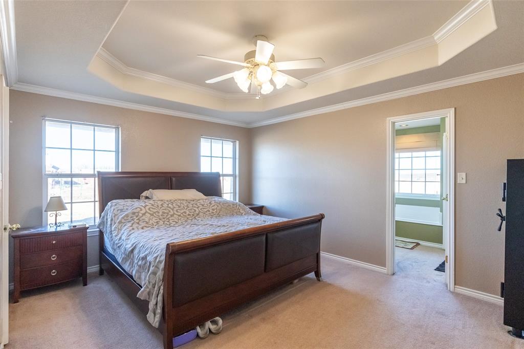 2166 County Road 131 Tuscola, TX 79562 - Photo 25 of 40 a bedroom with a bed and a chandelier