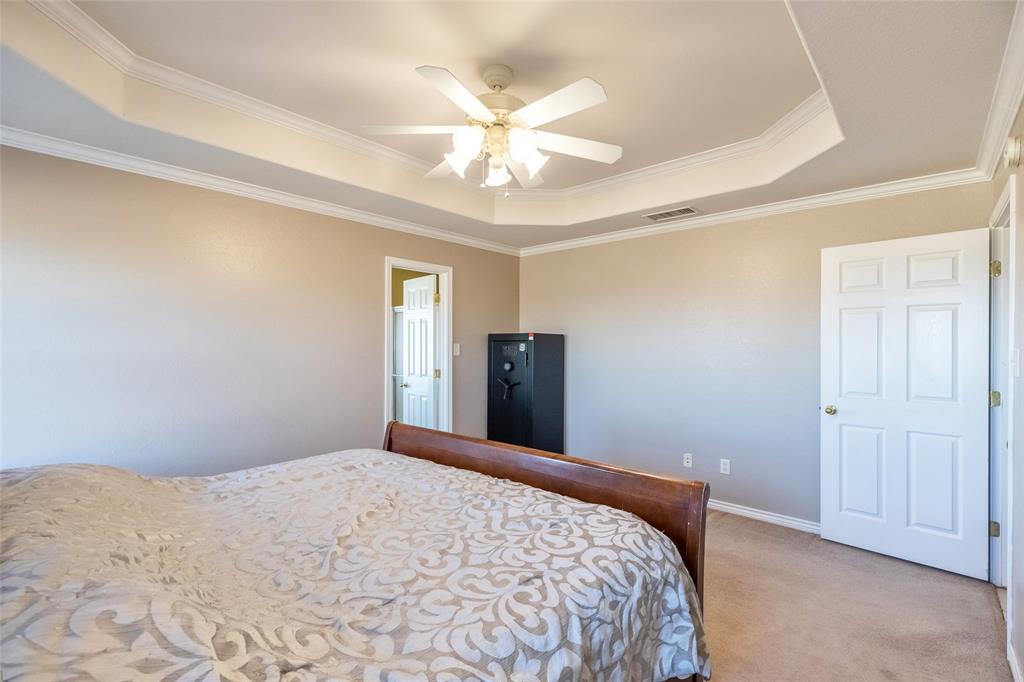 2166 County Road 131 Tuscola, TX 79562 - Photo 26 of 40 a bedroom with a large bed and a chandelier