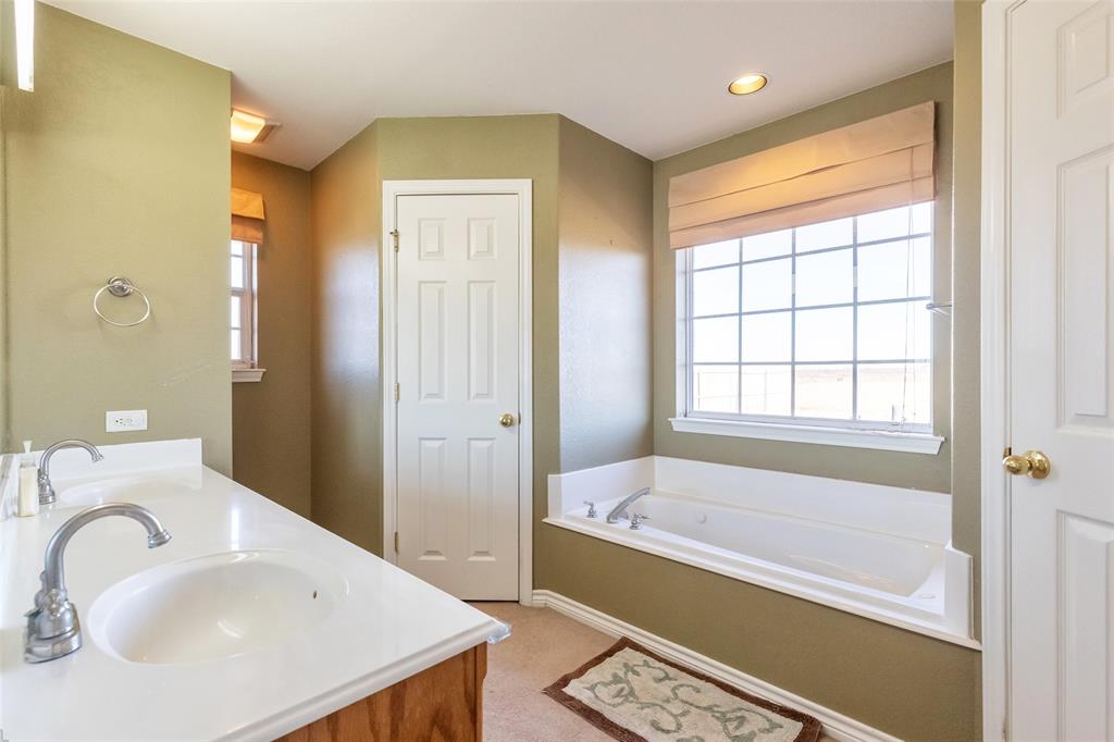 2166 County Road 131 Tuscola, TX 79562 - Photo 27 of 40 a bathroom with a sink and a bathtub