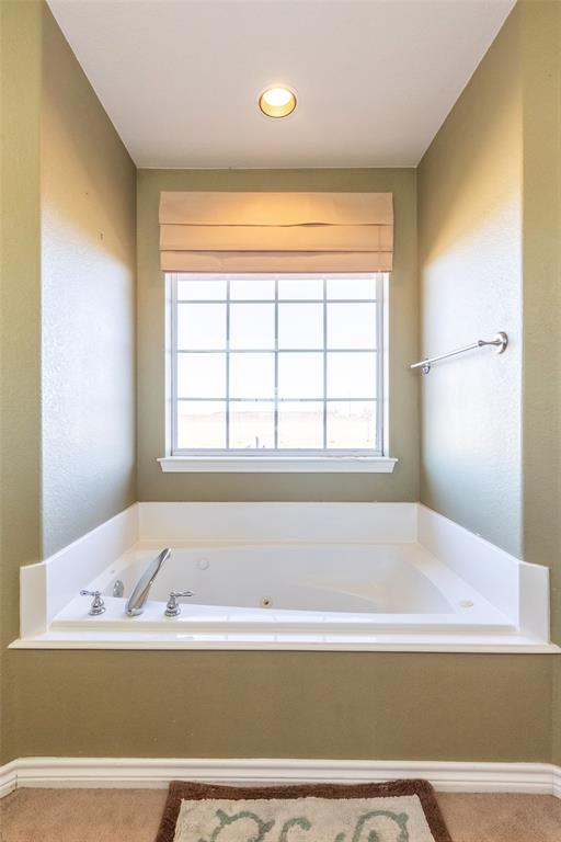 2166 County Road 131 Tuscola, TX 79562 - Photo 29 of 40 a bathroom with a bathtub and next to a window