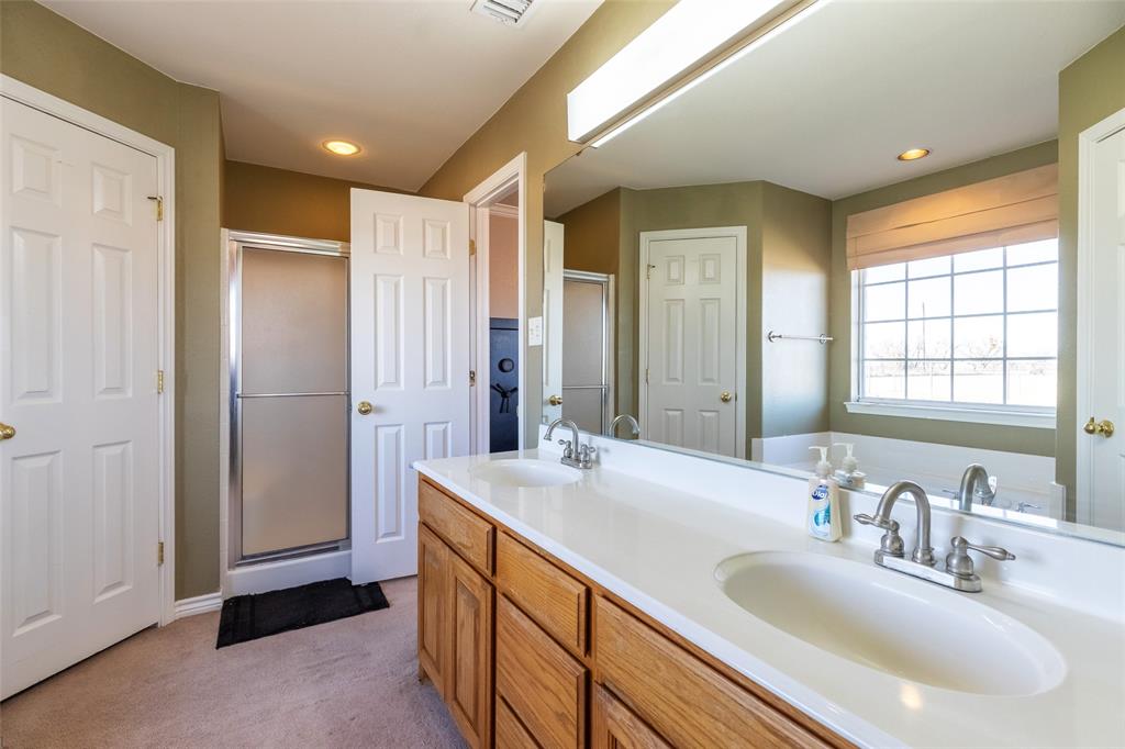 2166 County Road 131 Tuscola, TX 79562 - Photo 30 of 40 a bathroom with a double vanity sink and a mirror