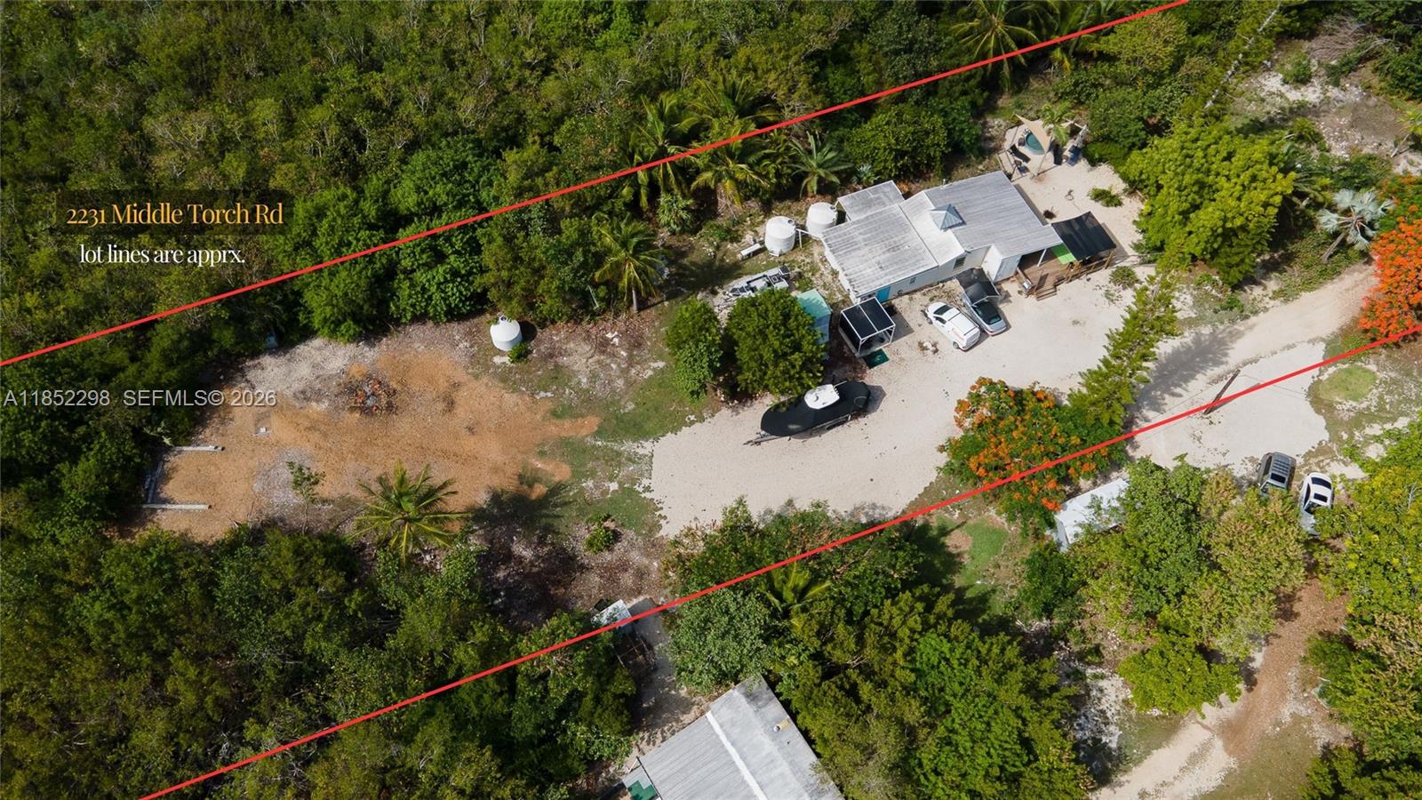 2231 Middle Torch Road Summerland Key, FL 33042 - Photo 19 of 36 a view of a house with a lake and a forest