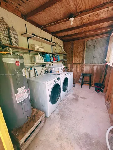 an aerial view of residential house with outdoor space and trees all around