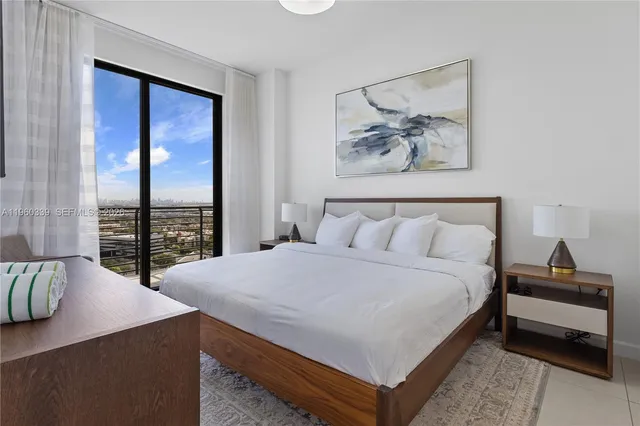 a bedroom with a bed and a large window