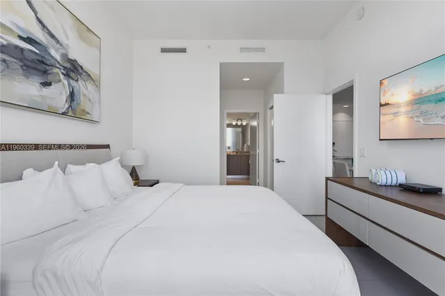 a bedroom with a bed and wall painting