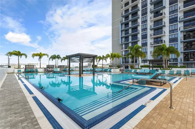 a view of swimming pool with outdoor seating and city view