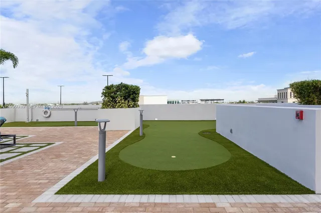 a view of a swimming pool with a yard