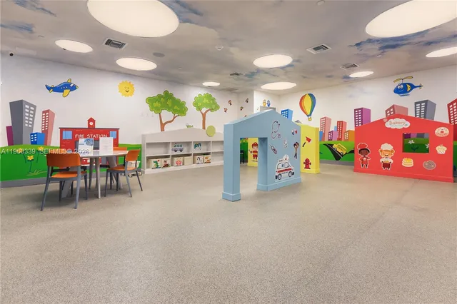 a view of a play room with furniture and toys