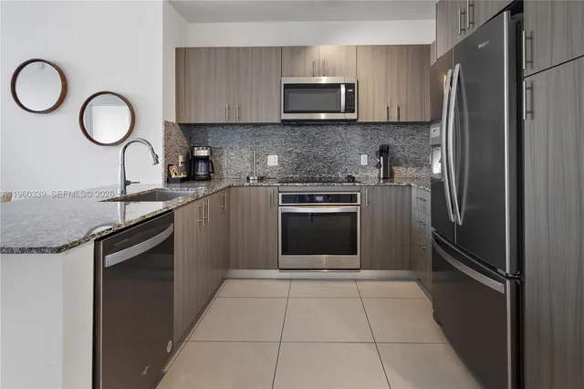a kitchen with a sink stove and refrigerator