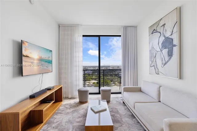 a living room with furniture and a flat screen tv