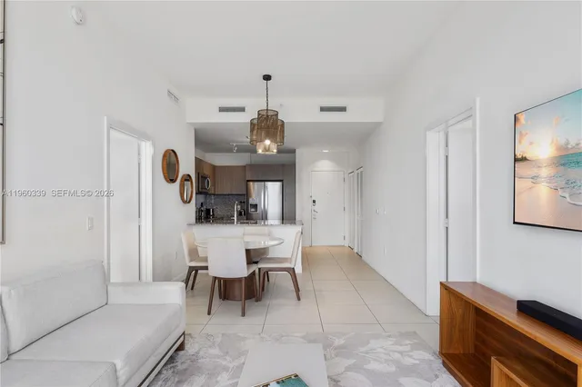 a living room with furniture and a piano