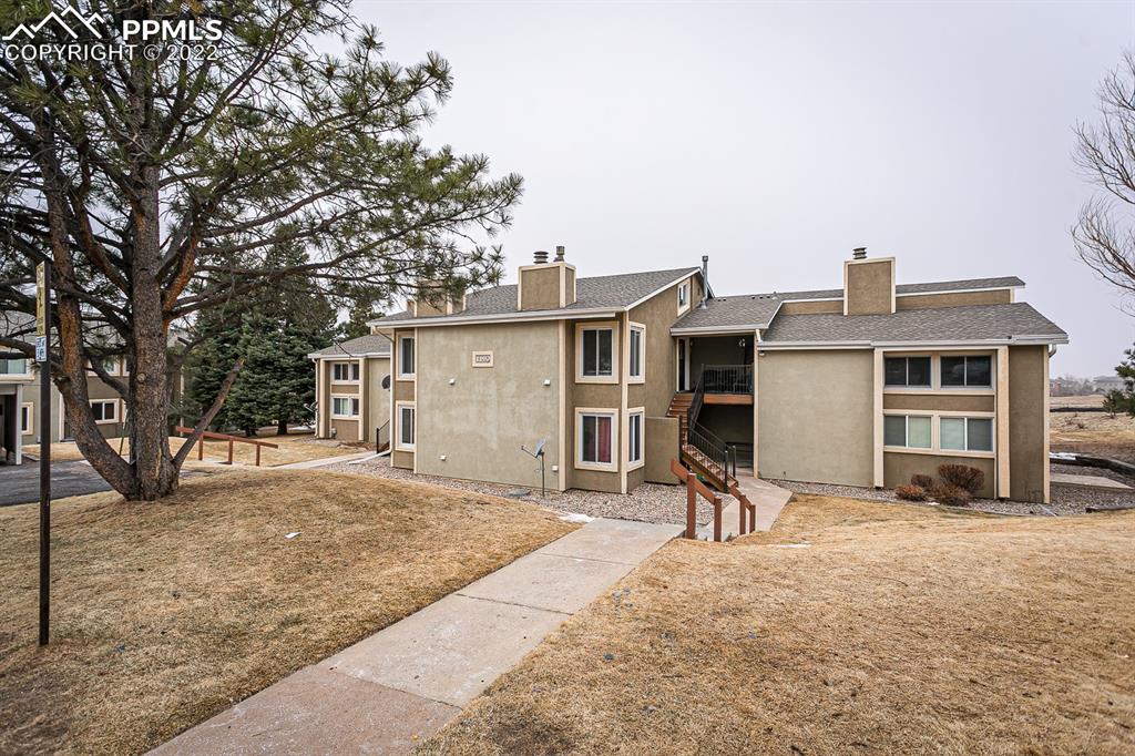 1140 Magic Lamp Way, Unit 3 Monument, CO 80132 - Photo 1 of 26 a house that has a tree in front of it